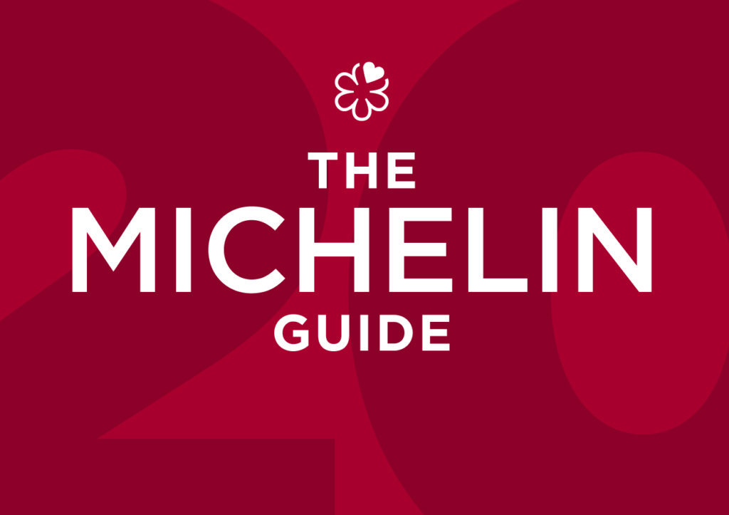 The cover of the 2018 Michelin Guide, featuring the iconic Michelin Man (Bibendum) illustration in blue and white.
